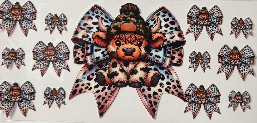 Brown spotted highland cow w/ bow