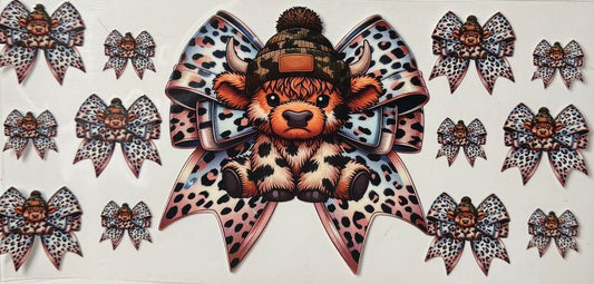 Brown spotted highland cow w/ bow